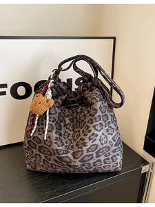 Leopard print bucket bag with drawstring closure and cute brown plush bear pendant