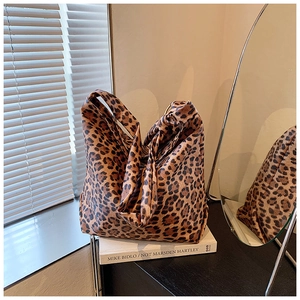 Macro detail of leopard print bucket bag made of soft fabric in a cozy studio setting