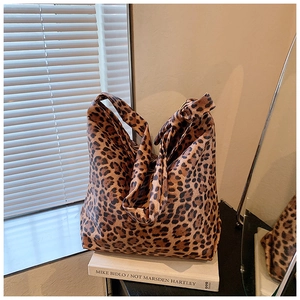 Detailed view of vintage leopard print hobo bag texture and large shoulder strap design