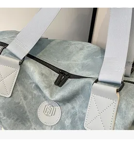 Detailed close-up of blue travel bag showing durable zippers and NING JIA logo