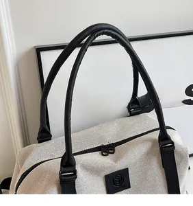 Detail of mesh storage tote bag with reinforced handles and double zipper closure