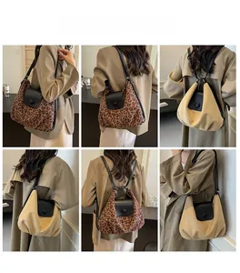 Detail view of large leopard print and beige tote bag showing shoulder strap and leather flap