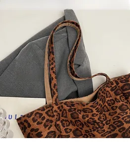 Detailed macro view of leopard print tote bag with thick canvas texture and durable strap
