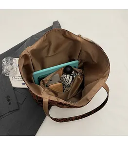 Top view of leopard print tote bag interior showing large capacity for tablet and phone