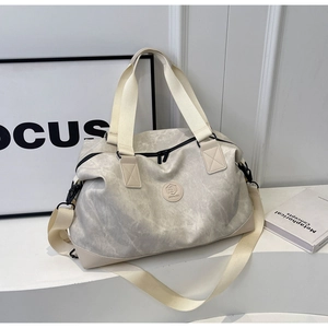 Close-up of marble texture travel bag with adjustable strap and wide handles on white surface