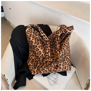 Detailed close-up of a leopard print tote bag placed on a minimalist chair for daily commute