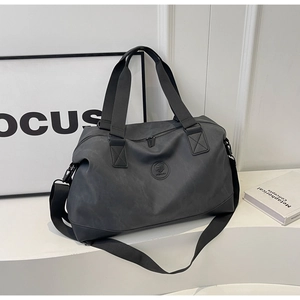 Waterproof nylon travel duffel bag with dual handles and adjustable shoulder strap for fitness