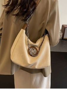 Vintage beige suede hobo bag with gold M logo and chain strap for autumn winter style