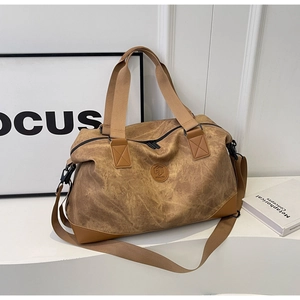 Close-up of brown travel bag with round leather logo and durable fabric texture