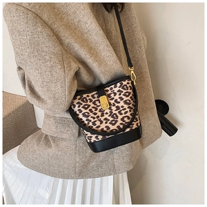 Detail of leopard print bucket bag with black leather trim and gold twist lock