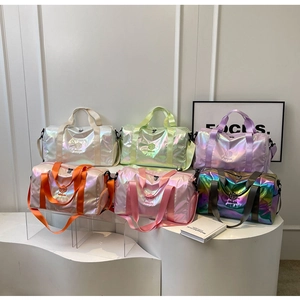 Iridescent laser fabric travel bags in six vibrant colors displayed on white pedestals