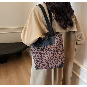 Leopard print tote bag styled with a beige trench coat for a chic commuting look