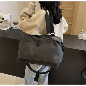 Detail view of the large travel bag showing back-carry style and adjustable shoulder strap