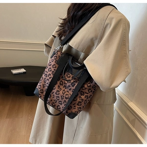 Detailed view of leopard print tote bag with reinforced leather corners and wide strap