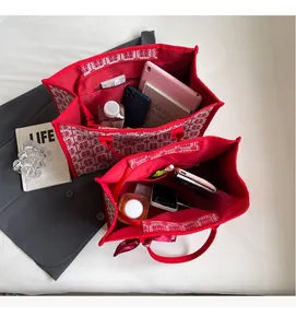 Detail view of red bridal tote bags with traditional double happiness jacquard pattern