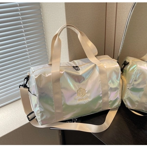 Iridescent pearlescent travel bag showing waterproof fabric and adjustable shoulder strap