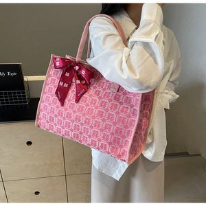 Detailed shot of pink canvas wedding tote bag with Xi character jacquard and red ribbon