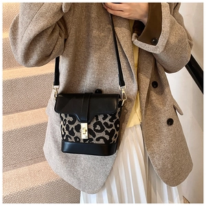 Detailed view of vintage leopard print crossbody bucket bag with gold metal buckle