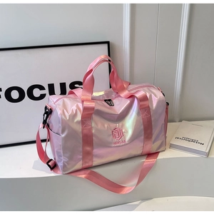 Close-up of holographic travel bag showing pink pearlescent fabric and side compartment