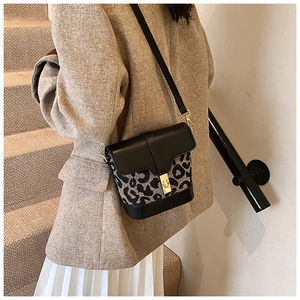 Close-up of leopard print bucket bag with premium gold buckle and leather trim