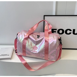 Macro detail of pink holographic travel bag showing NINGJIA embroidery and metallic finish