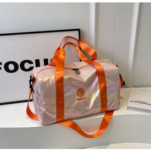 Detailed macro view of pearlescent waterproof fabric and orange woven straps on travel bag