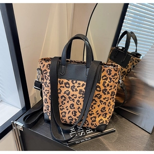 Leopard print canvas bucket bag with black lychee leather trim and wide strap