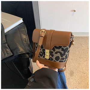 Detail of vintage leopard print crossbody bag with golden square twist lock