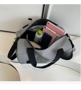 Open fitness bag showing spacious interior with tablet, water bottle and umbrella