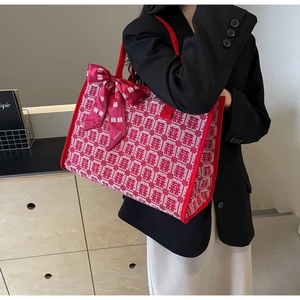 Close-up of red and white wedding tote bag with Xi character jacquard and silk bow