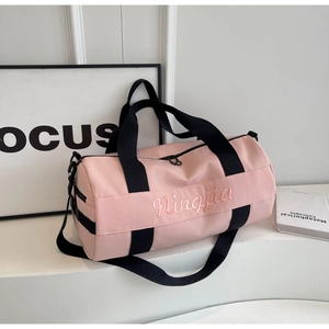 Pink cylinder gym bag with black straps and Ningjia embroidery for travel and fitness