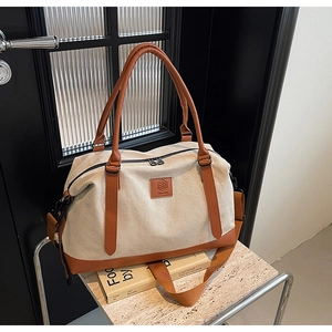 Detail showing durable canvas travel bag with leather accents and secure metal zippers