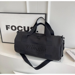Detail of Ningjia black fitness bag showing embroidered logo and durable canvas texture