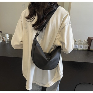 Vue détaillée du sac bandoulière croissant en nylon noir avec large sangle