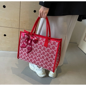 Detail of red and white woven bridal tote bag with traditional Xi character and bow