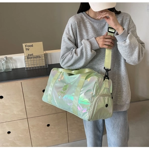 Close-up of holographic light green gym bag with waterproof texture and side zip pocket