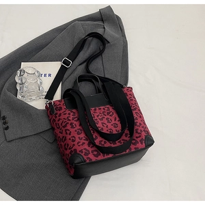 Top view of leopard print tote bag with black leather base and adjustable shoulder strap