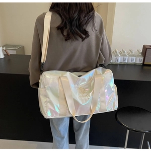 Model wearing white iridescent duffel bag showing high-capacity design and rainbow gloss