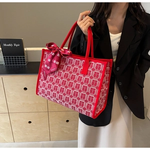 Macro view of red wedding tote bag featuring traditional Xi character jacquard pattern