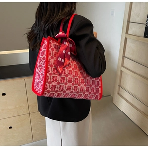Detail of red wedding tote bag with traditional Xi character jacquard and silk scarf decor