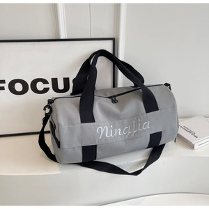 Spacious grey fitness bag with top zipper and durable black straps for travel and sports