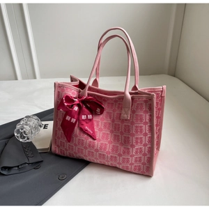 Detail of pink wedding tote bag with double happiness texture and red satin bow ribbon