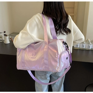 Detail of lavender iridescent travel bag showing metallic texture and brand logo