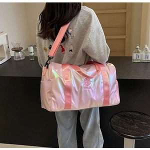 Detailed view of pink iridescent travel bag with NINGJIA embroidery and shoulder strap