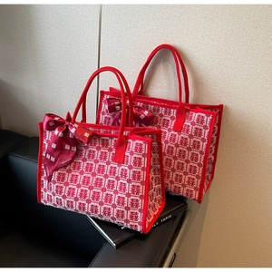 Detail of red wedding tote bag with Double Happiness pattern and silk scarf handle