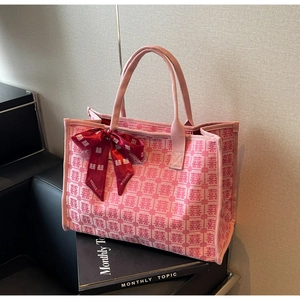 Detail of pink bridal canvas tote with red Xi characters and satin bow decoration