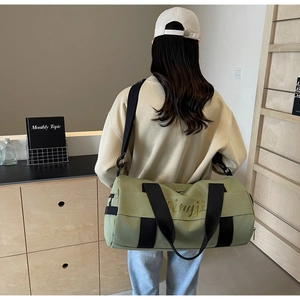 Olive green canvas sports bag featuring gold embroidery and adjustable shoulder strap
