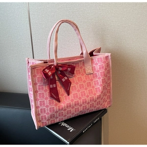 Detail of pink canvas tote bag with red Xi characters and silk ribbon bow accent