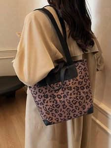 Leopard print tote bag with black leather trim and wide shoulder strap for women