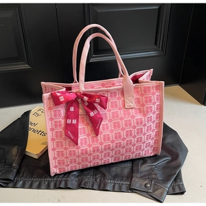 Close-up of pink bridal tote bag featuring red double happiness jacquard and brand ribbon